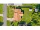 Aerial view of a house with a brown roof, lush lawn, landscaping, and a storage shed in the backyard at 22 Banyan Dr, Ocala, FL 34472