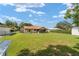 Large backyard with lush green grass, a screened-in patio, and ample space for relaxation and recreation at 22 Banyan Dr, Ocala, FL 34472