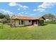 A lovely backyard featuring a screened lanai, a well-maintained lawn, and a fenced perimeter at 22 Banyan Dr, Ocala, FL 34472