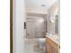 Cozy bathroom features a shower-tub combo with sliding glass doors and a neutral color palette at 22 Banyan Dr, Ocala, FL 34472