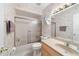 Well-maintained bathroom features a shower-tub combo, tile floors, and vanity with ample lighting at 22 Banyan Dr, Ocala, FL 34472