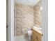 Cozy bathroom showcases a patterned wallpaper, a toilet, and a vanity with a sink at 22 Banyan Dr, Ocala, FL 34472