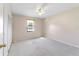 Bright bedroom with a ceiling fan and large window overlooking the front yard at 22 Banyan Dr, Ocala, FL 34472