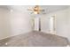 Comfortable bedroom includes neutral carpet, a ceiling fan, and access to an en-suite bathroom at 22 Banyan Dr, Ocala, FL 34472