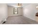 Bright bedroom with neutral carpet, ceiling fan, and a window providing natural light at 22 Banyan Dr, Ocala, FL 34472