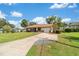 Large driveway and well-manicured front lawn enhancing this inviting single-Gathering home at 22 Banyan Dr, Ocala, FL 34472