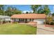 Landscaped front yard highlighting the home's brick accents, shutters, and driveway at 22 Banyan Dr, Ocala, FL 34472