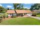 Well-maintained home featuring mature landscaping, a lush lawn, and an inviting curb appeal at 22 Banyan Dr, Ocala, FL 34472