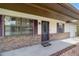Charming home featuring a brick facade, front porch, and well-maintained landscaping at 22 Banyan Dr, Ocala, FL 34472