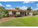 Traditional single-story home showcasing a brick facade and vibrant landscaping at 22 Banyan Dr, Ocala, FL 34472