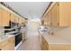 Spacious kitchen features tile floors, light wood cabinets, and appliances, blending style and functionality at 22 Banyan Dr, Ocala, FL 34472