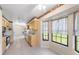 Well-lit kitchen features tile floors, light wood cabinets, and windows overlooking the backyard at 22 Banyan Dr, Ocala, FL 34472