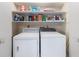 Convenient laundry room featuring a washer, dryer, and ample shelving for storage at 22 Banyan Dr, Ocala, FL 34472