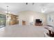 Bright living room featuring tile floors, a ceiling fan, and views of the kitchen at 22 Banyan Dr, Ocala, FL 34472