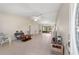 Bright living room featuring tile floors, a ceiling fan, and sliding glass doors to outdoor area at 22 Banyan Dr, Ocala, FL 34472