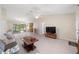 Bright living room featuring tile floors, a ceiling fan, and sliding glass doors to outdoor area at 22 Banyan Dr, Ocala, FL 34472