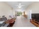 Bright living room featuring tile floors, a ceiling fan, and sliding glass doors to outdoor area at 22 Banyan Dr, Ocala, FL 34472