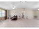 Living room with vaulted ceiling, tile flooring, and large windows providing natural light at 22 Banyan Dr, Ocala, FL 34472
