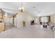Open-concept floor plan featuring living room and kitchen with vaulted ceilings, tile flooring, and ample natural light at 22 Banyan Dr, Ocala, FL 34472