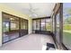 This airy sunroom includes a ceiling fan, light-colored floors, and sliding glass doors for easy outdoor access at 22 Banyan Dr, Ocala, FL 34472