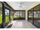 Spacious sunroom with a ceiling fan and plenty of windows, perfect for enjoying the view of the backyard at 22 Banyan Dr, Ocala, FL 34472