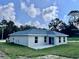 Backyard featuring sliding doors, new roof and a green lawn at 3 Dogwood Drive Loop, Ocala, FL 34472
