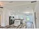 Open concept kitchen with white cabinets, stainless steel appliances, and eat-in island at 3 Dogwood Drive Loop, Ocala, FL 34472