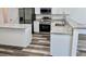 Modern kitchen featuring white cabinets, granite countertops, and stainless steel appliances at 3 Dogwood Drive Loop, Ocala, FL 34472