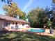 Outdoor pool with lounge chairs surrounded by bamboo and lush landscaping creates a private backyard oasis at 4780 Se 33Rd Ave, Ocala, FL 34480