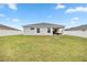 Open backyard with a covered patio, ideal for enjoying outdoor living and entertaining guests at 5537 Se 91St Pl, Ocala, FL 34480