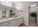 Bathroom features double sinks, vanity, and walk-in closet with ample storage space at 5537 Se 91St Pl, Ocala, FL 34480