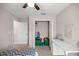 Bedroom features a ceiling fan, a desk with drawers, and a closet with an opened door and filled with toys at 5537 Se 91St Pl, Ocala, FL 34480