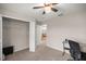 Bedroom featuring a ceiling fan, a small desk, and a closet with an open door to the bedroom at 5537 Se 91St Pl, Ocala, FL 34480