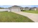 A charming house with a two-car garage, well-manicured lawn, and white picket fence at 5537 Se 91St Pl, Ocala, FL 34480