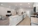 Bright open kitchen with island and stainless steel appliances flows into the living area at 5537 Se 91St Pl, Ocala, FL 34480