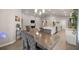 Open-concept living and dining area with modern decor and plenty of natural light at 5537 Se 91St Pl, Ocala, FL 34480