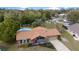 Aerial view of a cozy single-story home with a well-manicured lawn and a refreshing swimming pool in the backyard at 6136 Se 37Th Ter, Ocala, FL 34480