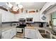 Kitchen area with white cabinets, stainless steel appliances, and granite countertops at 6136 Se 37Th Ter, Ocala, FL 34480