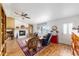 Cozy living room featuring a fireplace, ceiling fan, and comfortable seating area at 6136 Se 37Th Ter, Ocala, FL 34480