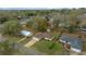 Aerial shot of a home with green grass, well-maintained bushes, and mature trees at 6718 Cherry Rd, Ocala, FL 34472