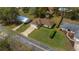 Aerial view of a well-maintained home, green lawn, mature trees, and a paved driveway at 6718 Cherry Rd, Ocala, FL 34472