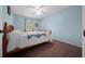 Bedroom with hardwood bed frame, carpet, and a window with curtains at 6718 Cherry Rd, Ocala, FL 34472