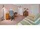 Bedroom featuring a futon, desk, carpet, and an entrance to an adjacent living area at 6718 Cherry Rd, Ocala, FL 34472