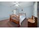 Bedroom featuring a hardwood bed frame, carpet, and a window with curtains at 6718 Cherry Rd, Ocala, FL 34472