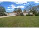 Charming single-story home featuring a well-manicured lawn and attached one car garage at 6718 Cherry Rd, Ocala, FL 34472