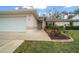 Close up of the front entrance to a single story home with a landscaped yard and beige paint at 6718 Cherry Rd, Ocala, FL 34472