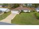 Exterior front elevation of a house with manicured lawn and attached garage at 6718 Cherry Rd, Ocala, FL 34472