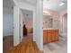 View of hallway leading into bedroom and bathroom with vanity and walk in shower at 6718 Cherry Rd, Ocala, FL 34472