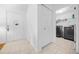 Bright hallway with tile floors, closet space, and convenient access to the laundry room at 6718 Cherry Rd, Ocala, FL 34472