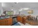 Open kitchen with stainless sink and appliances and adjacent dining area filled with natural light at 6718 Cherry Rd, Ocala, FL 34472